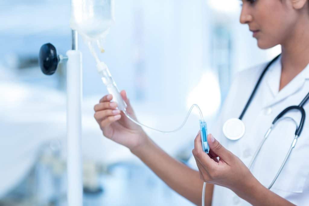 IV Therapy - Nurse connecting an intravenous drip